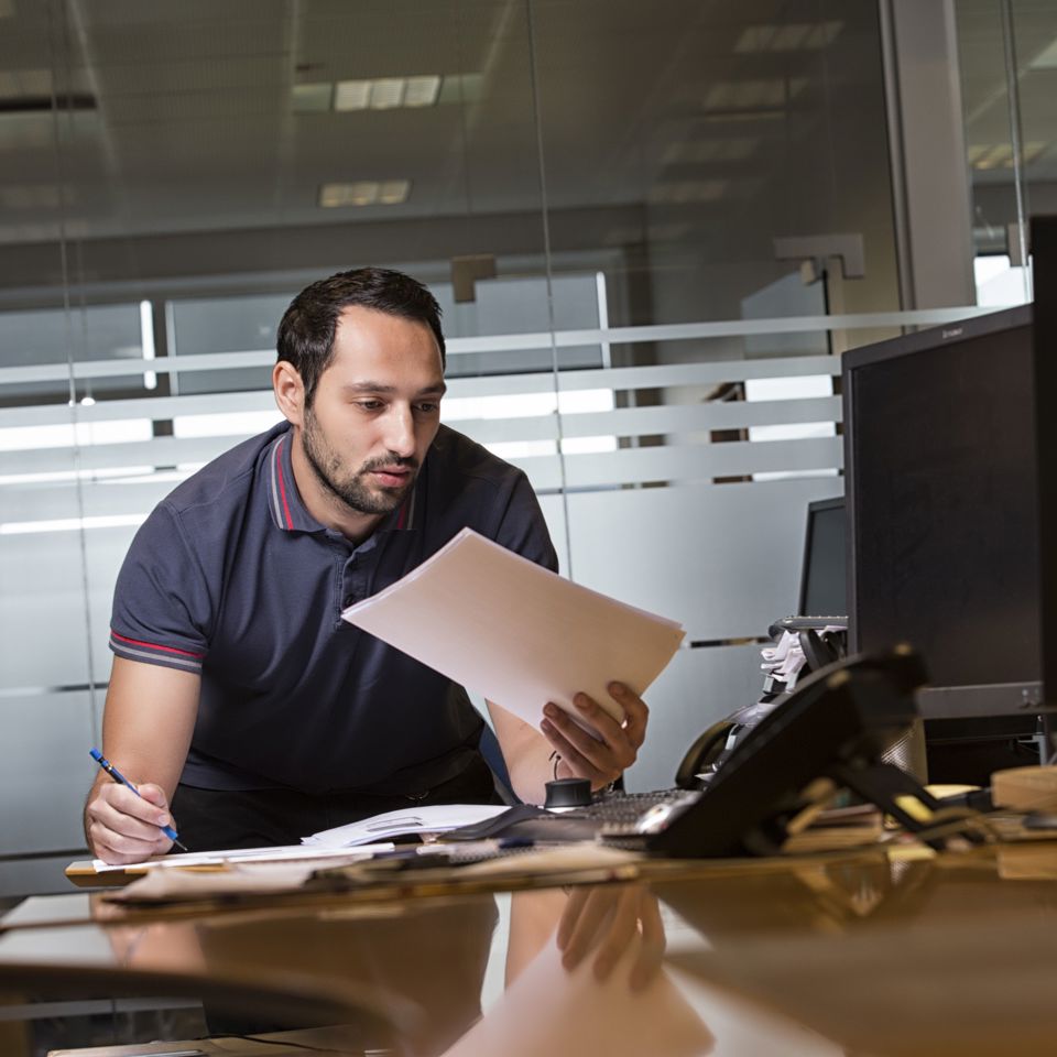 Terma employee looking at papers and making notes.