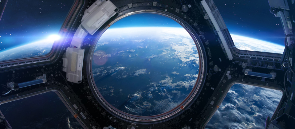 Earth seen from space through a space capsule.