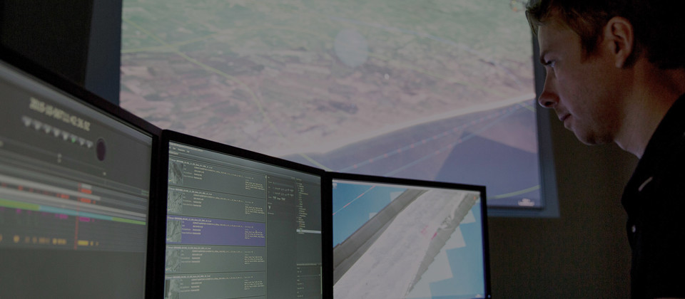 Man looking at JIMAPS in the command and control room.