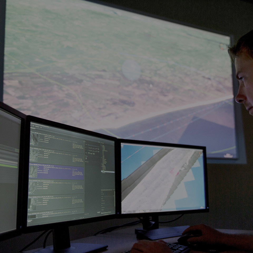 Man looking at JIMAPS in the command and control room.
