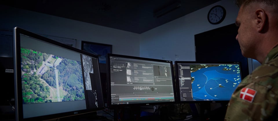 Danish Air Force employee looking at JIMAPS in the command and control room.