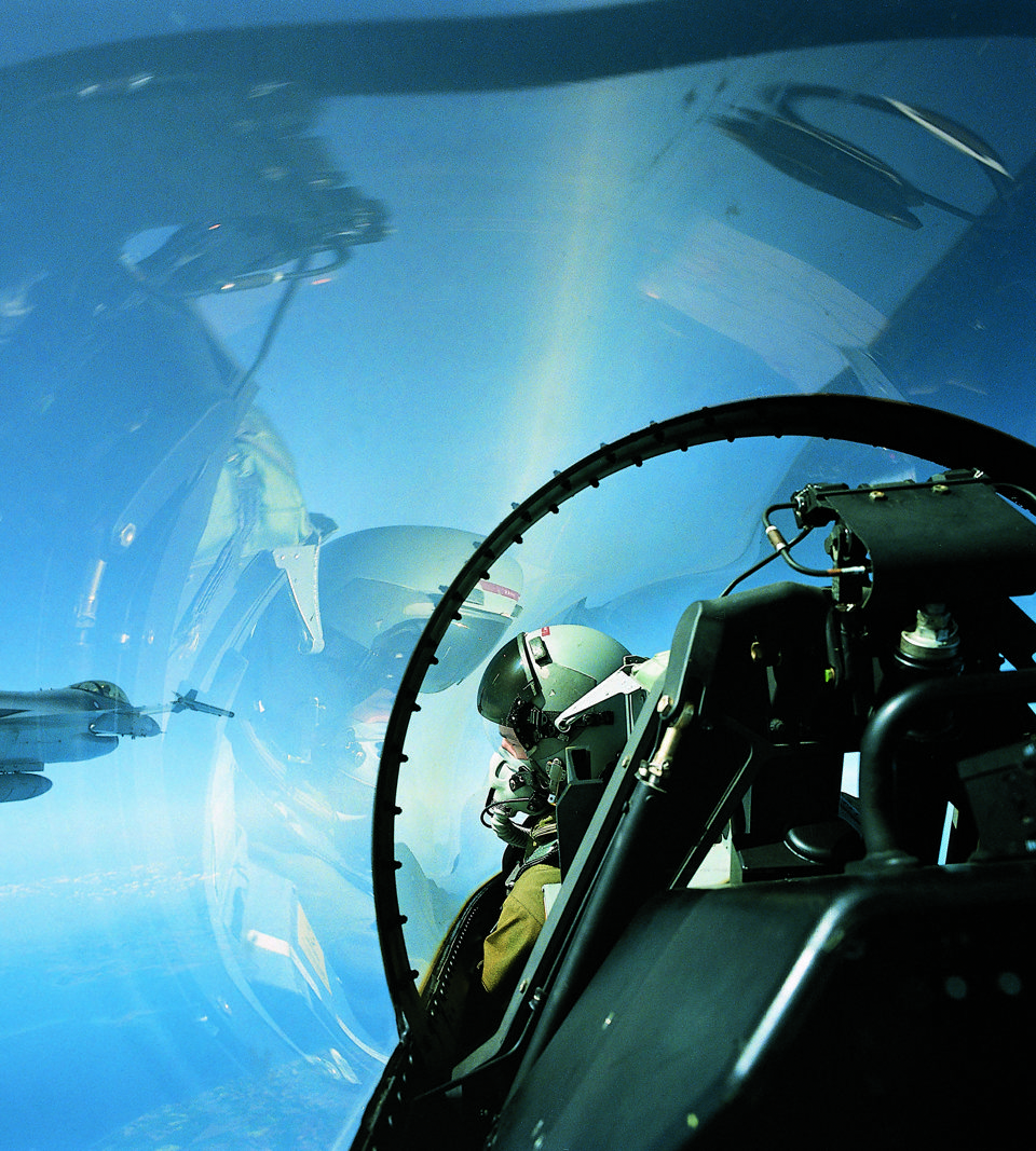 Pilot in F-16 cockpit with 3D-Audio headset.
