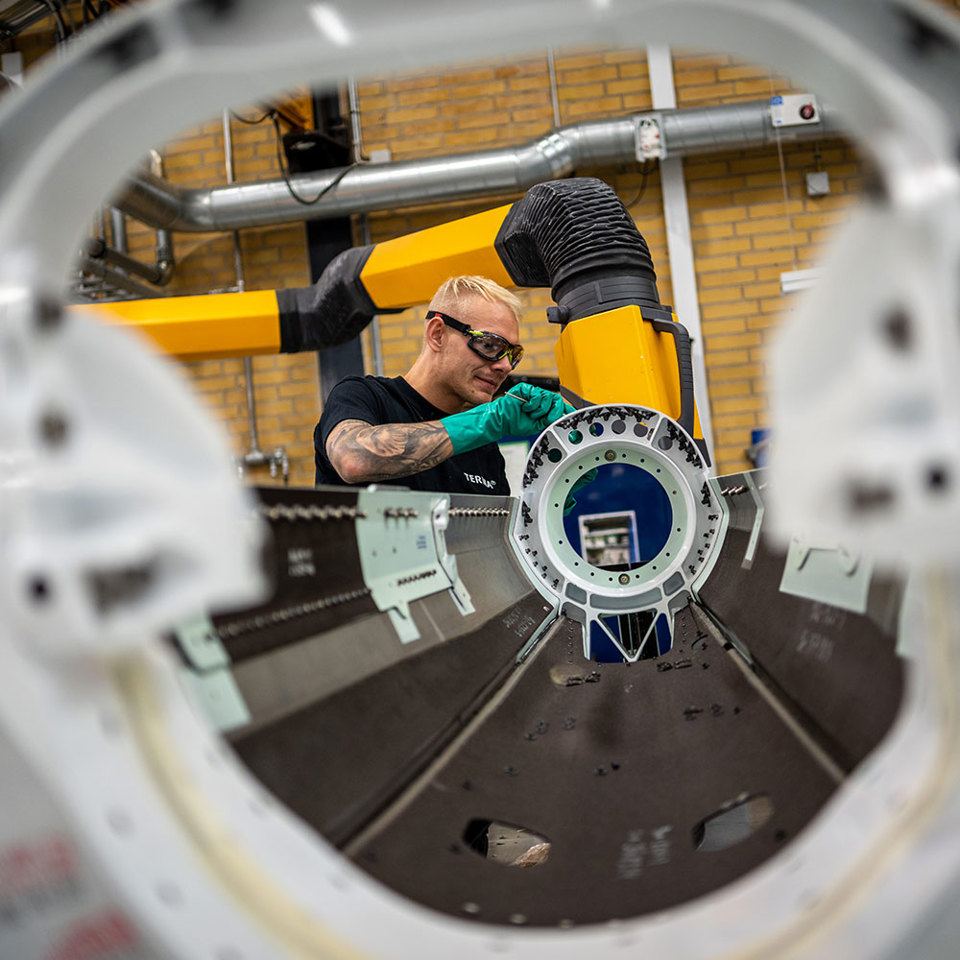 Employee assembling products at Terma's production facility in Denmark.