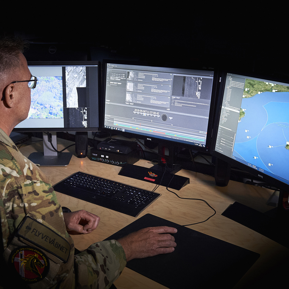 Danish Air Force employee looking at JIMAPS in the command and control room.