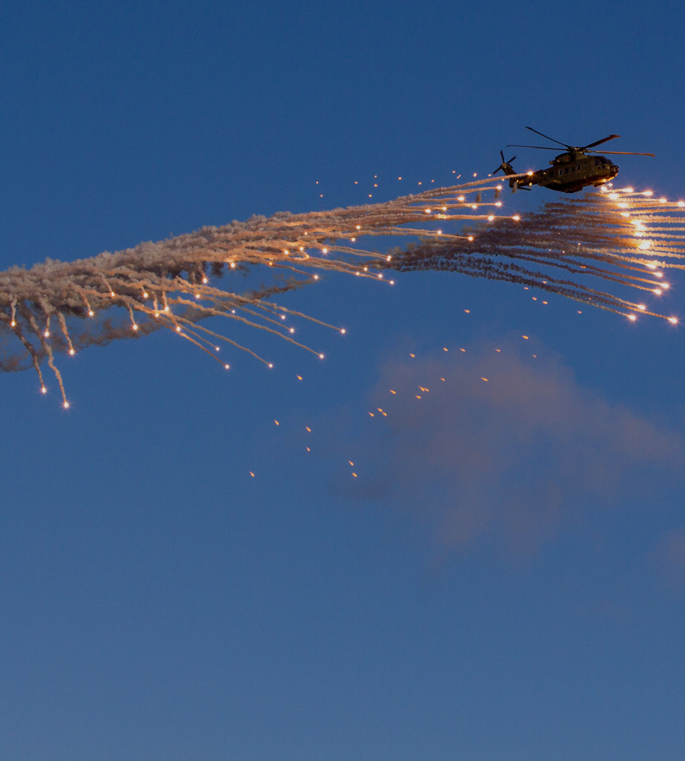 Danish EH101 helicopter ejecting flares overlay.