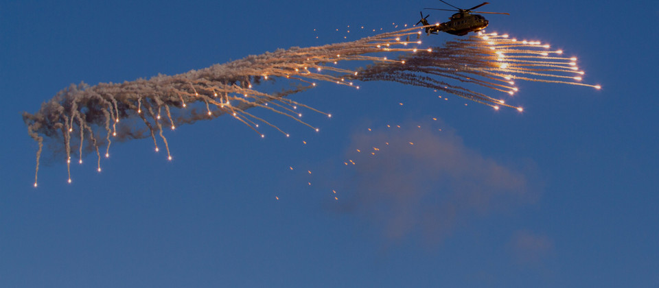 Danish EH101 helicopter ejecting flares overlay.