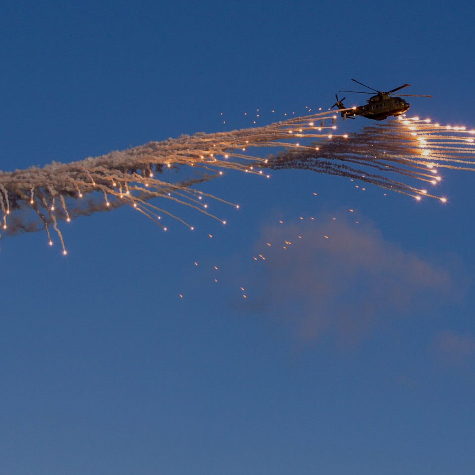 Danish EH101 helicopter ejecting flares overlay.