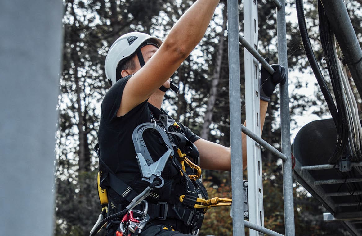 A man wearing a helmet and safety gear is climbing a ladder. AI generated content
