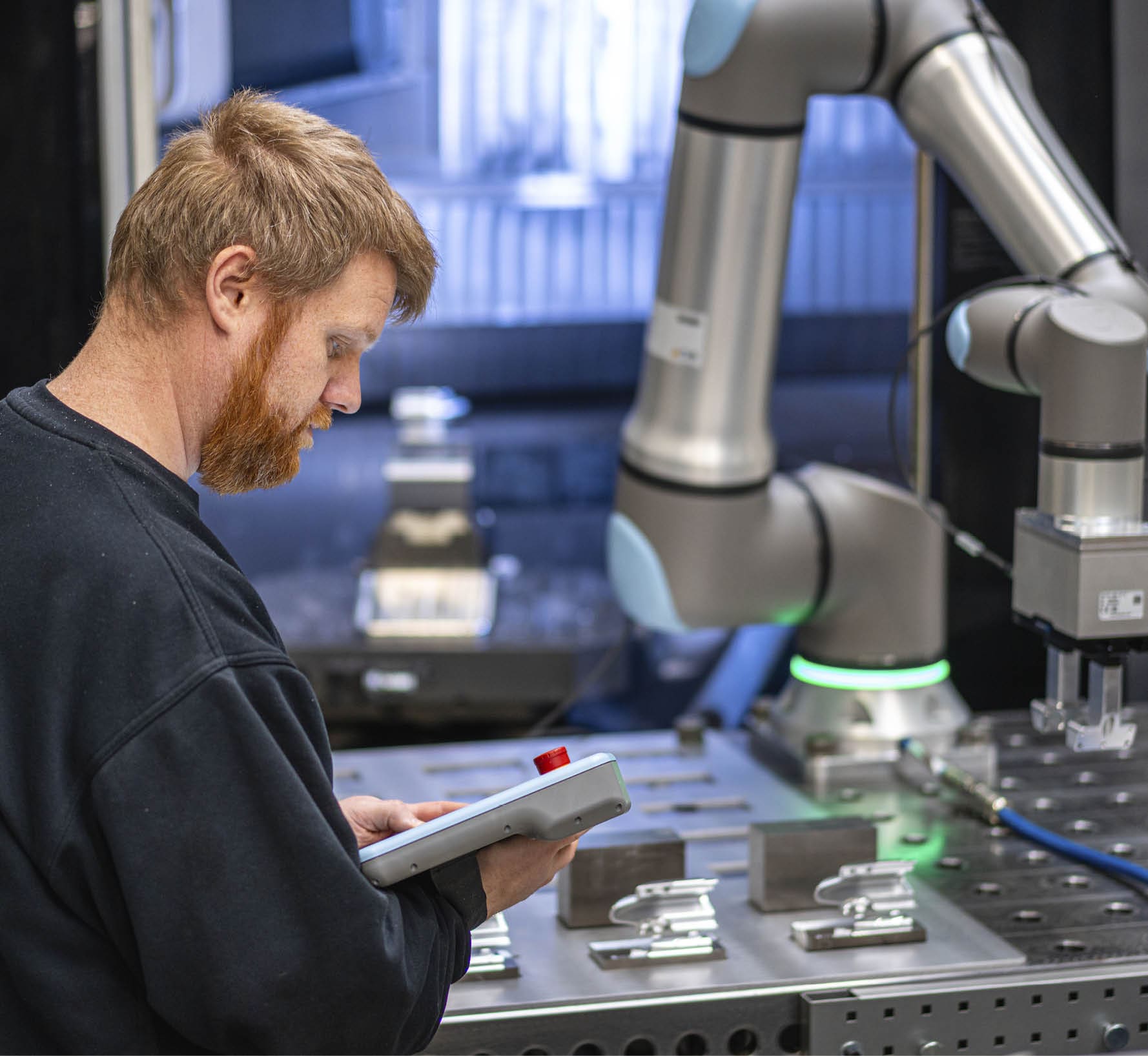 A man in a black shirt is working on a robotic machine. AI generated content