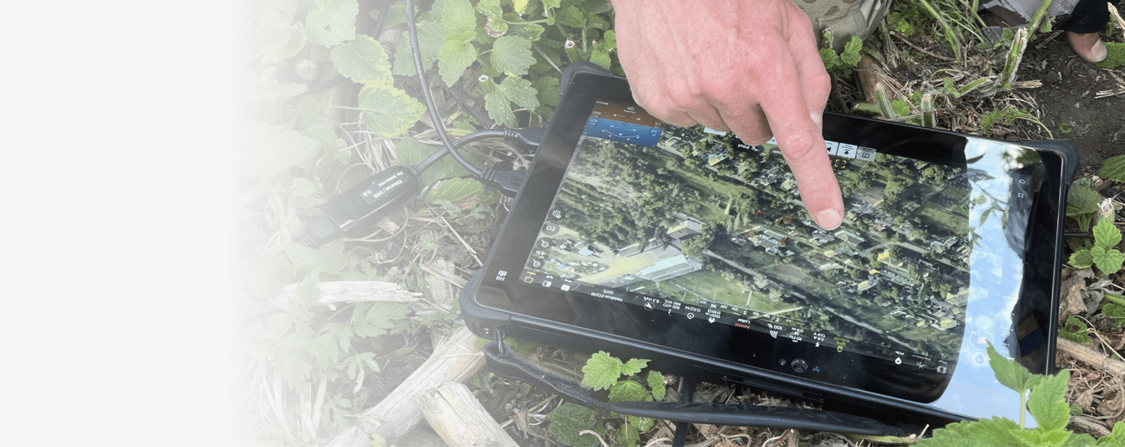 A man is pointing at a tablet computer. Description generated by AI