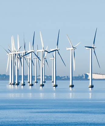 Offshore wind turbines on the coast of Copenhagen in Denmark with the airport in the background; Shutterstock ID 1216714066; purchase_order: -; job: -; client: -; other: -
